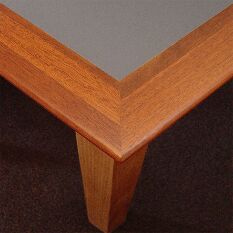 detail corner of a custom designed desk with inset coloured corkboard worksurface
