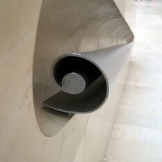 organic spiral steel handrail, recessed in the stone wall, as good to hold as it is to look at