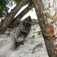 a simple canoe and orange bark highlights in the Solomon Islands
