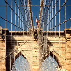 Brooklyn Bridge, with solid, cathedral towers & webs of steel rope : the world's best bridge